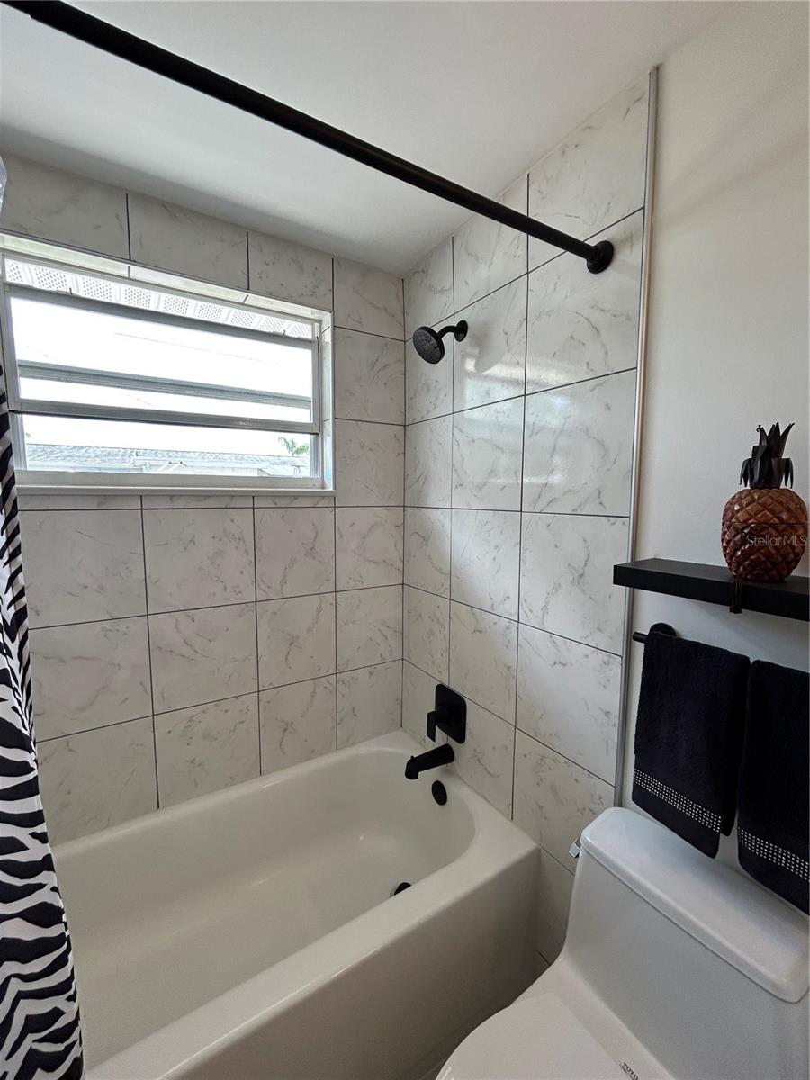 Tiled walls and tastefully  upgraded.