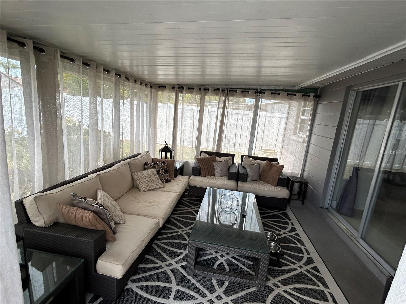 Need more space picture relaxing in a full screened in porch area.