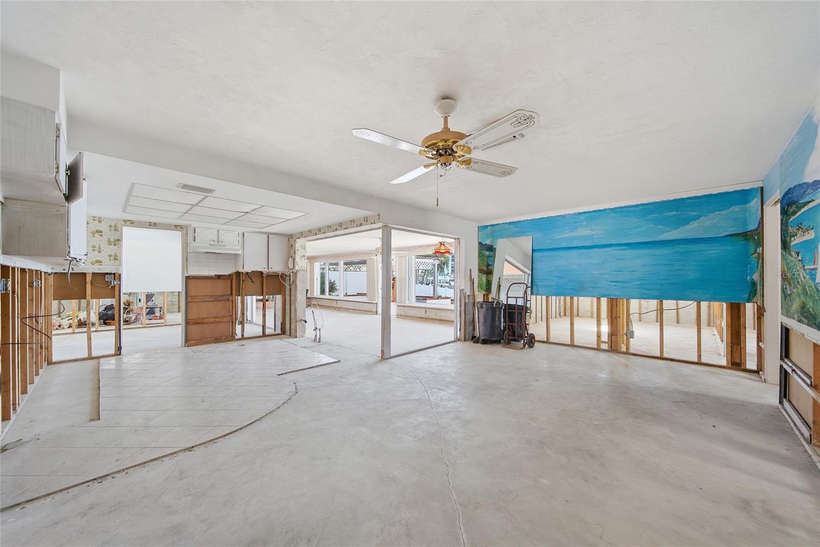 View from back of existing dining room looking southeast towards kitchen on left and family room in the rear center.