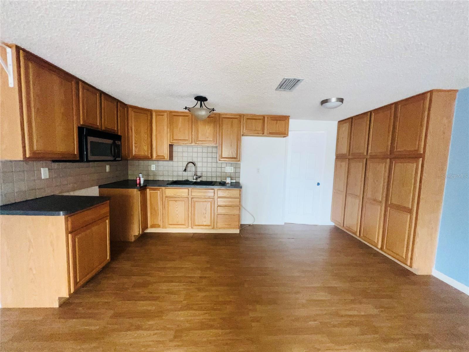 VIEW OF KITCHEN FROM LIVING ROOM AREA