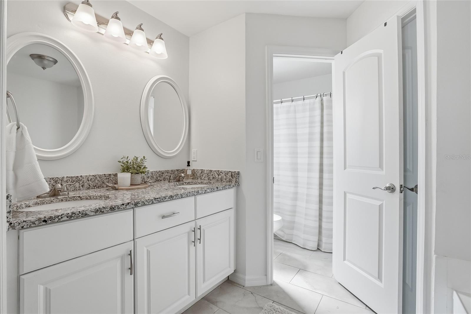 Primary suite bathroom with double vanity, garden tub and wlk-in shower