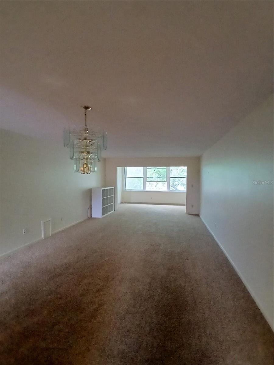 full living room with bonus room at the back.