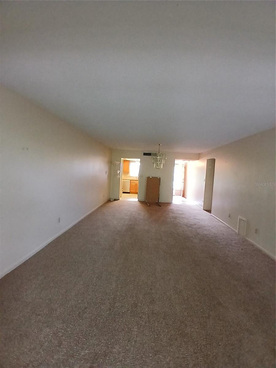 View of the living room looking toward the kitchen, dining area and front hall.