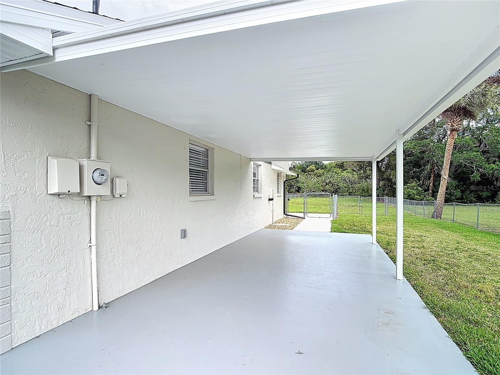 Huge carport and fenced in backyard for your doggies!