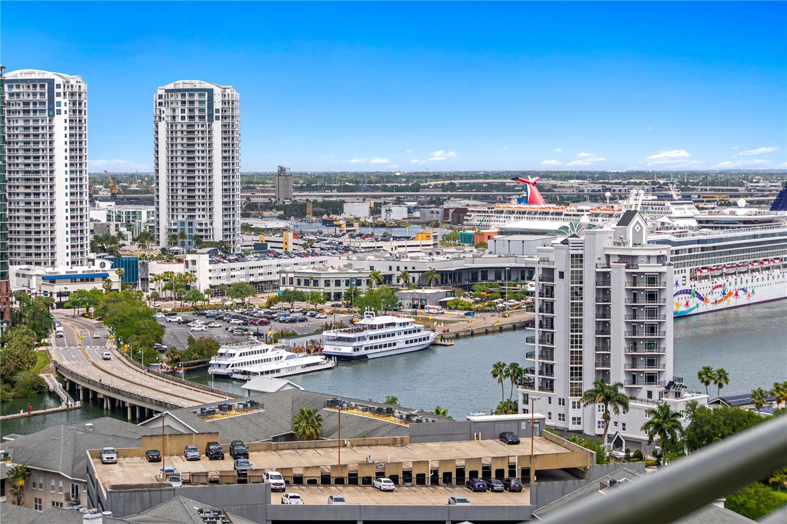 Enjoy sweeping city views from the balcony, showcasing Downtown Tampa, Sparkman Wharf, Benchmark Arena, and beyond