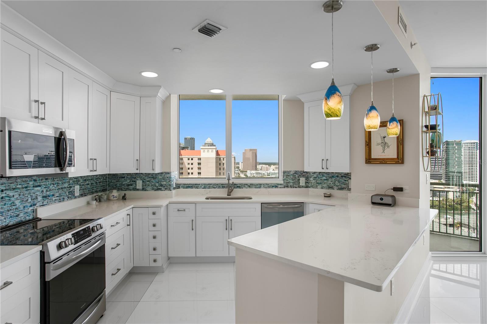 Well-appointed kitchen with ample countertop space and beautiful city views of Tampa.