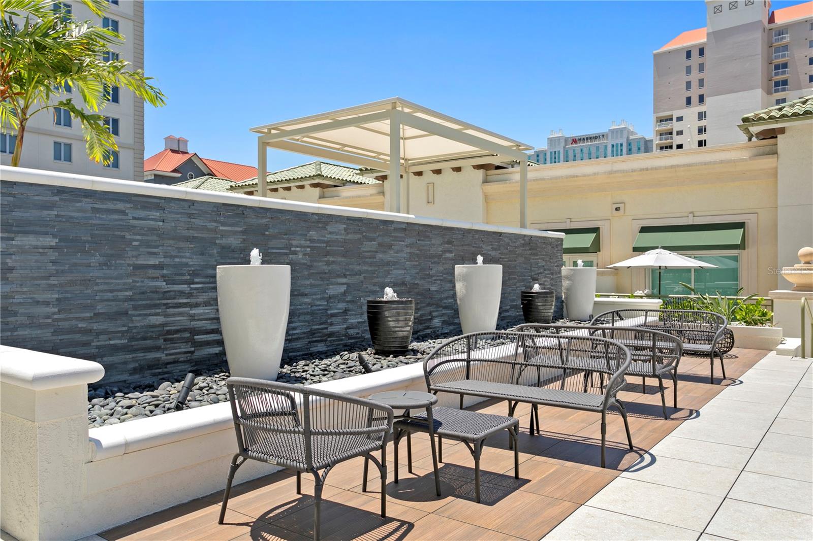 Beautiful fountains and water features surround the pool, complete with comfortable lounge seating.