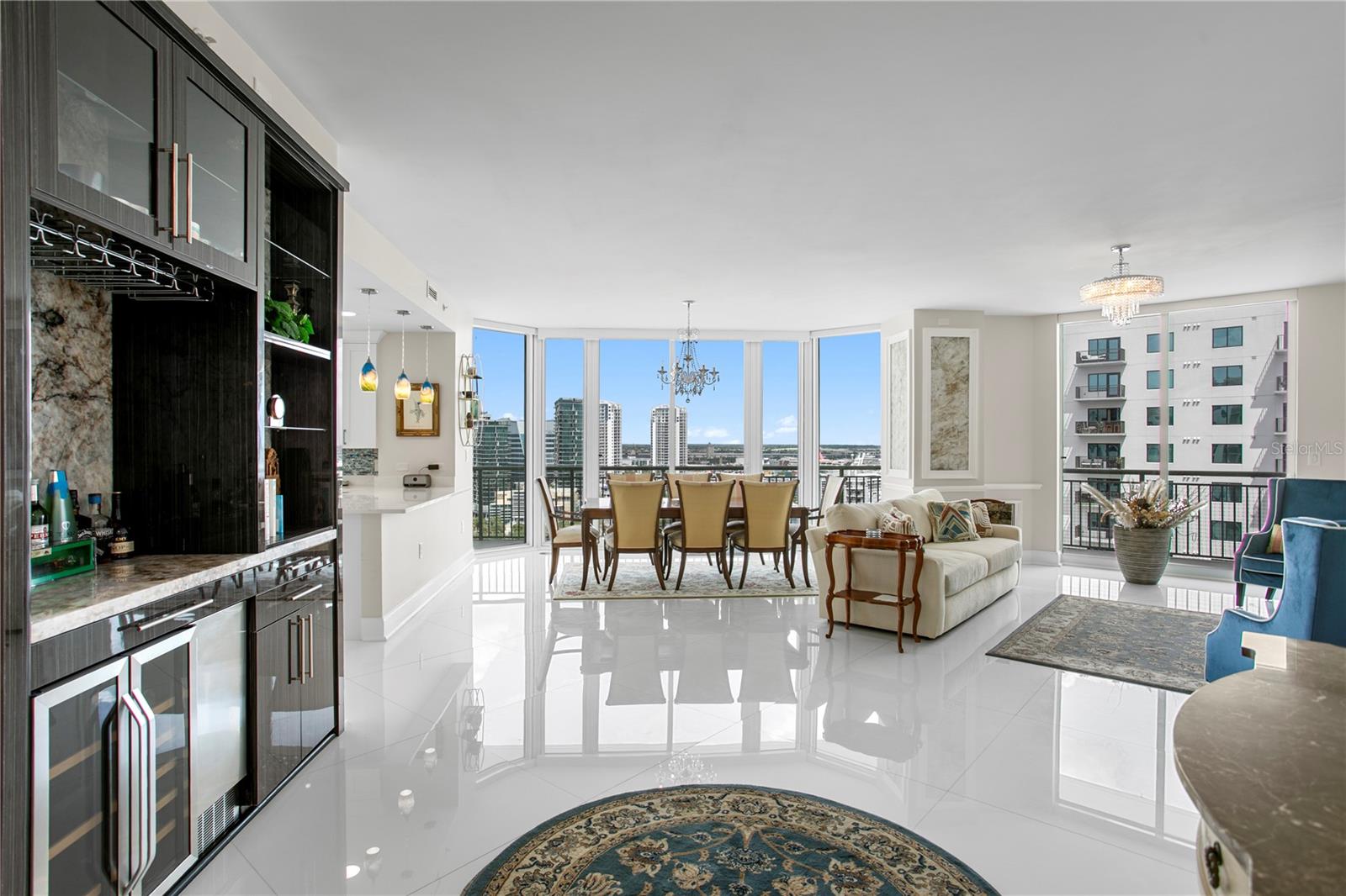 Seamless open-concept living with a wet bar, dining, and living areas—all flowing to a spacious balcony perfect for al fresco dining and entertaining.