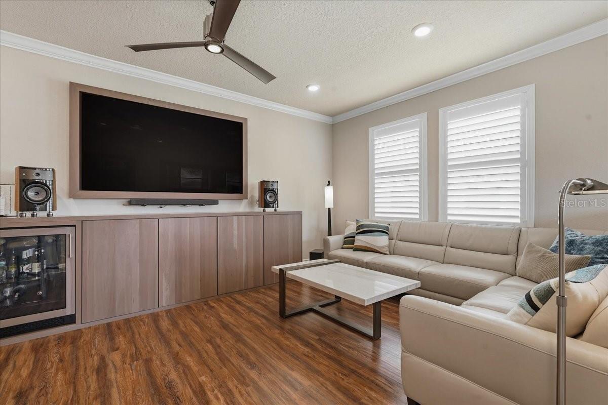 UPSTAIRS BONUS/LOFT AREA WITH CUSTOM BUILT WALNUT CABINETRY AND ENTERTAINING AREA!