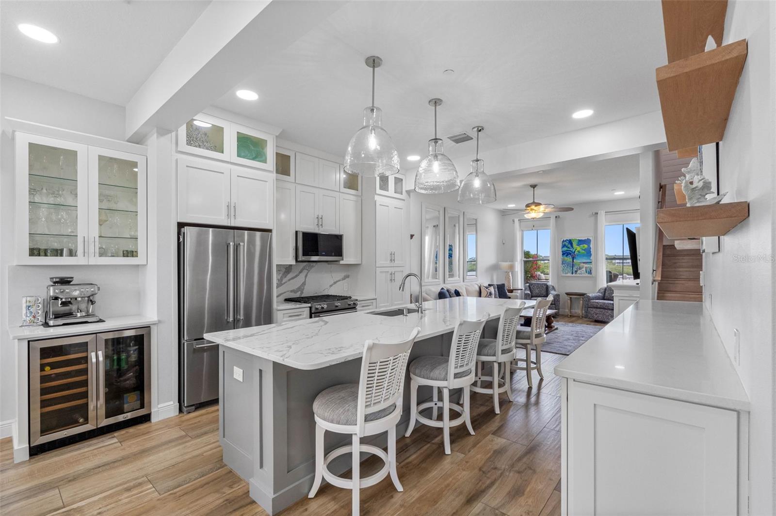 .. High Ceilings Compliment the Kitchen Area. NOTE: Upper Decorative glass front display cabinets with crown molding. Coffee Bar with Wine Refrigerator and Upper Glass Front Display Cabinet