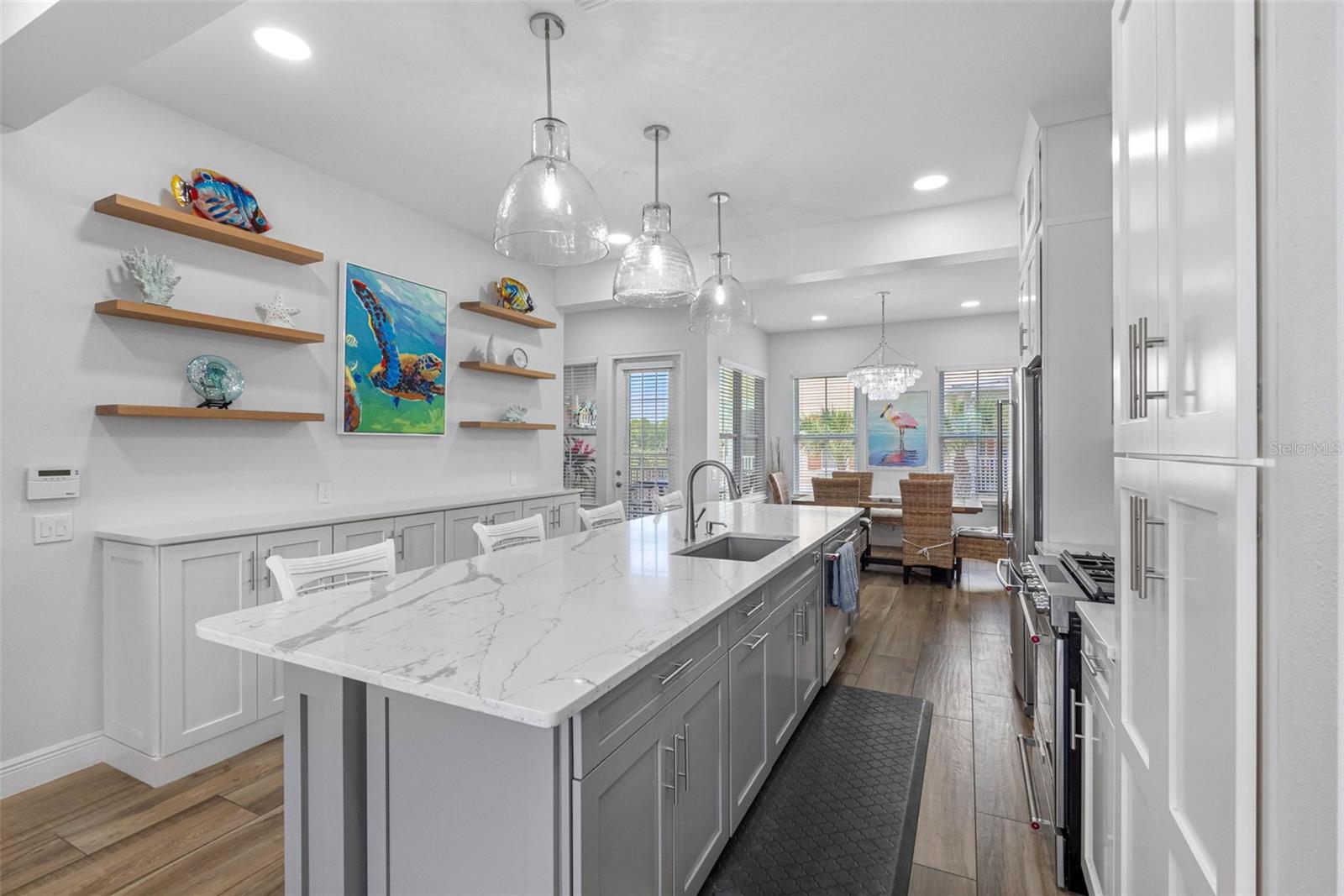 .. 18 Foot Kitchen. Perfect For Family Entertaining.. 3 Bell shaped 17 “ Recycled Glass Hand Blown Pendant Lighting over Island. Blanco Large Sink. The Owners thougt of everything here.. Perfect Family Vacation Beach Getaway.