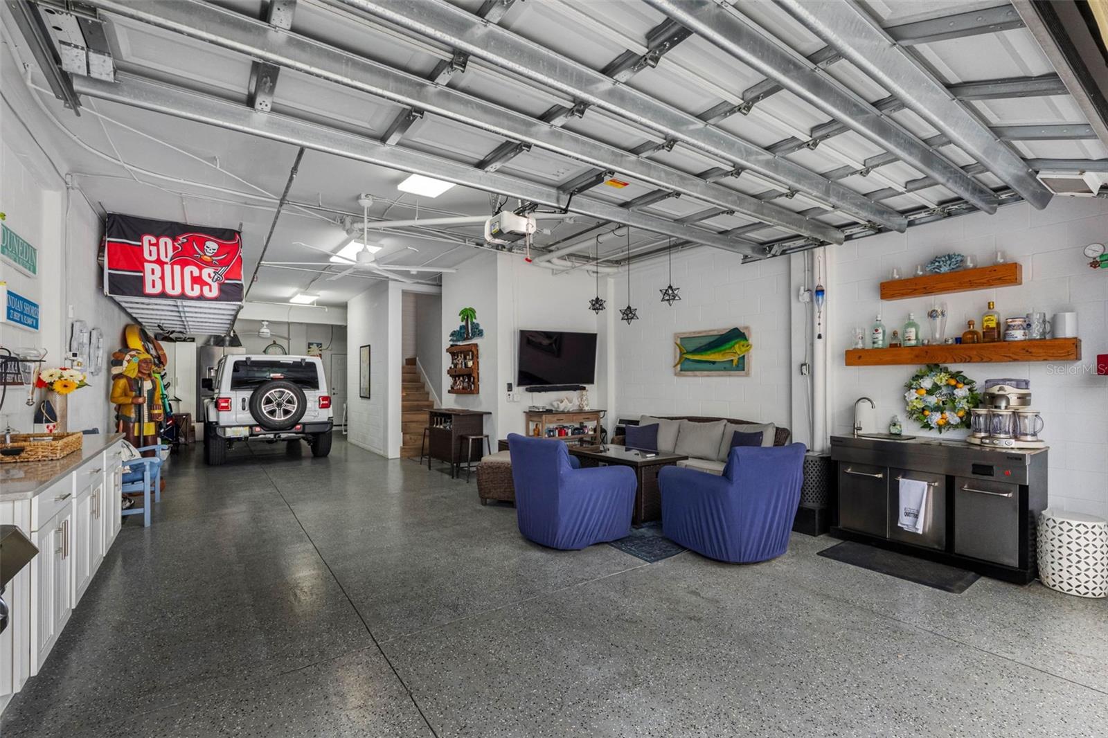 ... Sellers Use The Garage a Lot...  Extra 4 X 15 Storage Room in Rear of Garage. Elevator on All Floors including Garage Level + ( Television - Seating Area - Steel Sink Cabinet + Man Cave).