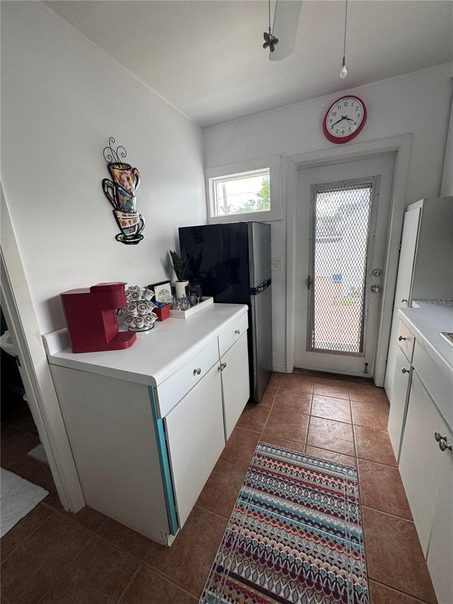 Back door leads to big fenced yard, studio and alley