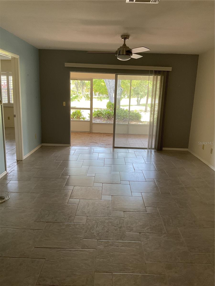 VIEW OF LIVING ROOM WITH SCREENED-IN PATIO