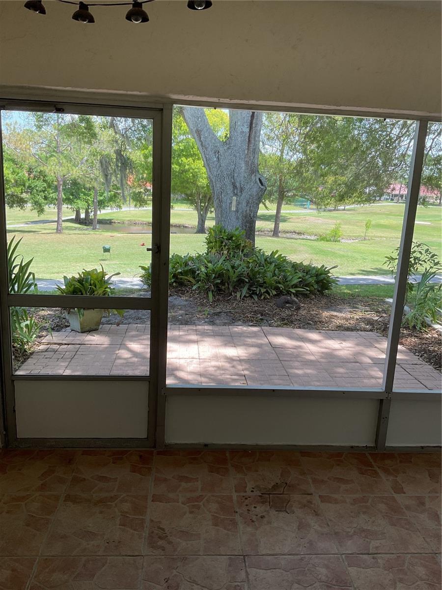 SCREENED IN PATIO WITH VIEW OF GOLF COURSE