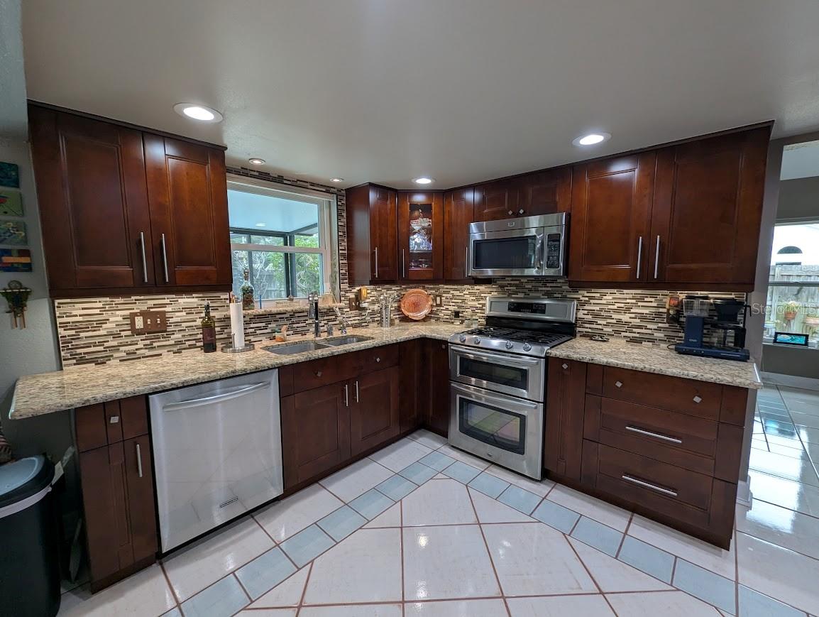Kitchen has updated finishes and cabinetry with stainless appliances