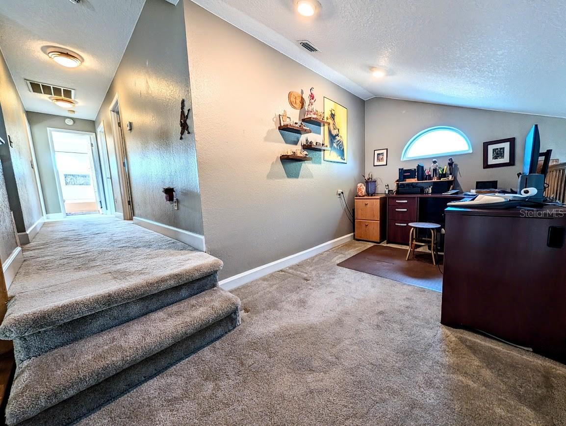 Loft and hallway leading to bedrooms and baths