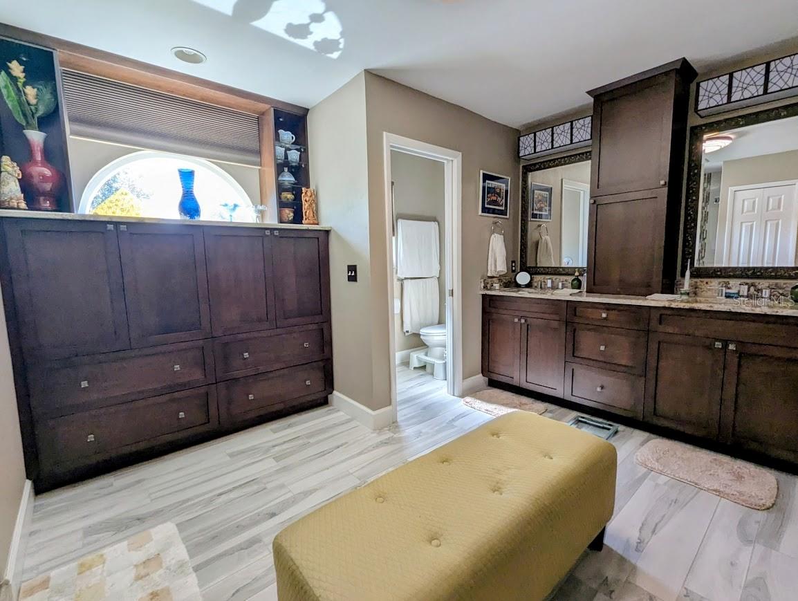 Custom cabinetry in ensuite, water closet, remote control shade