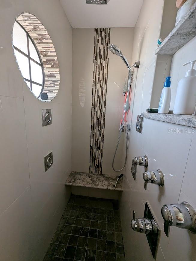 Large walk in shower has 6 shower heads