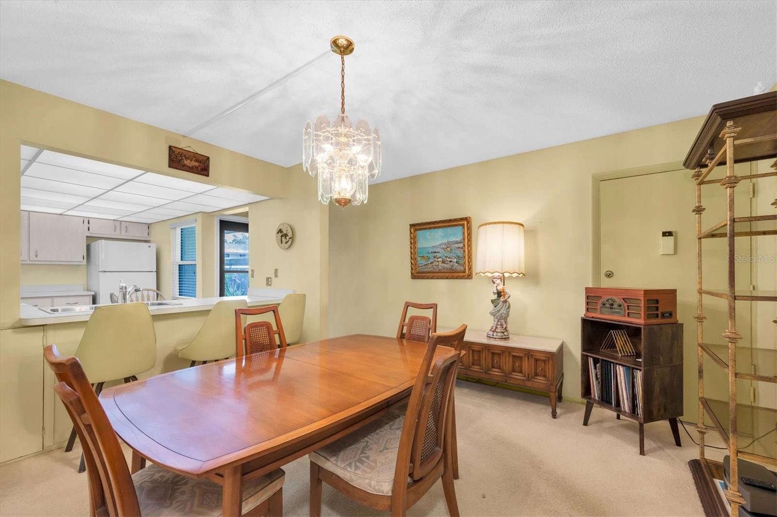 Dining Room with side view of Kitchen and Front Door to condo