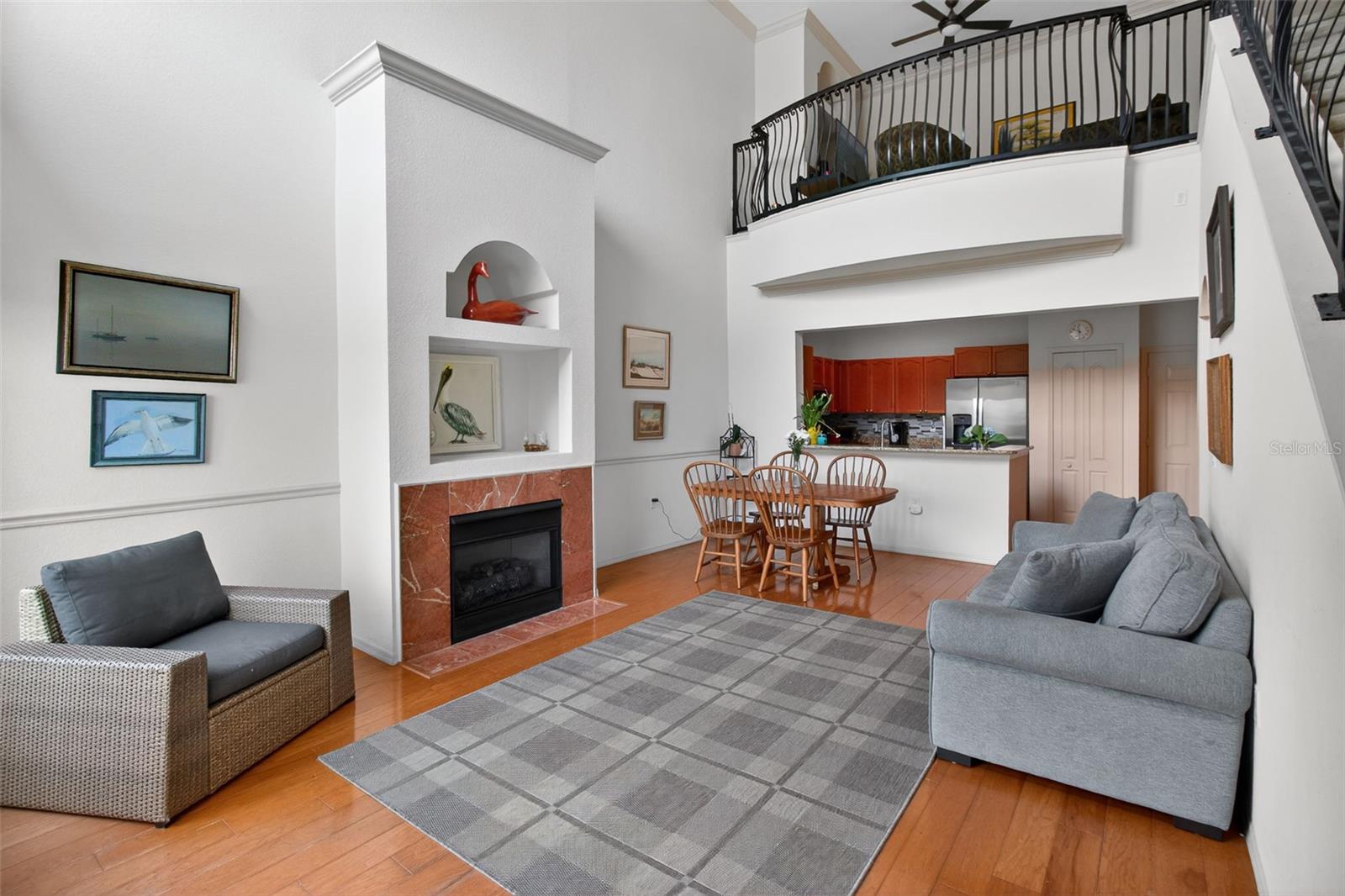 Living, dining, and kitchen open to family room above