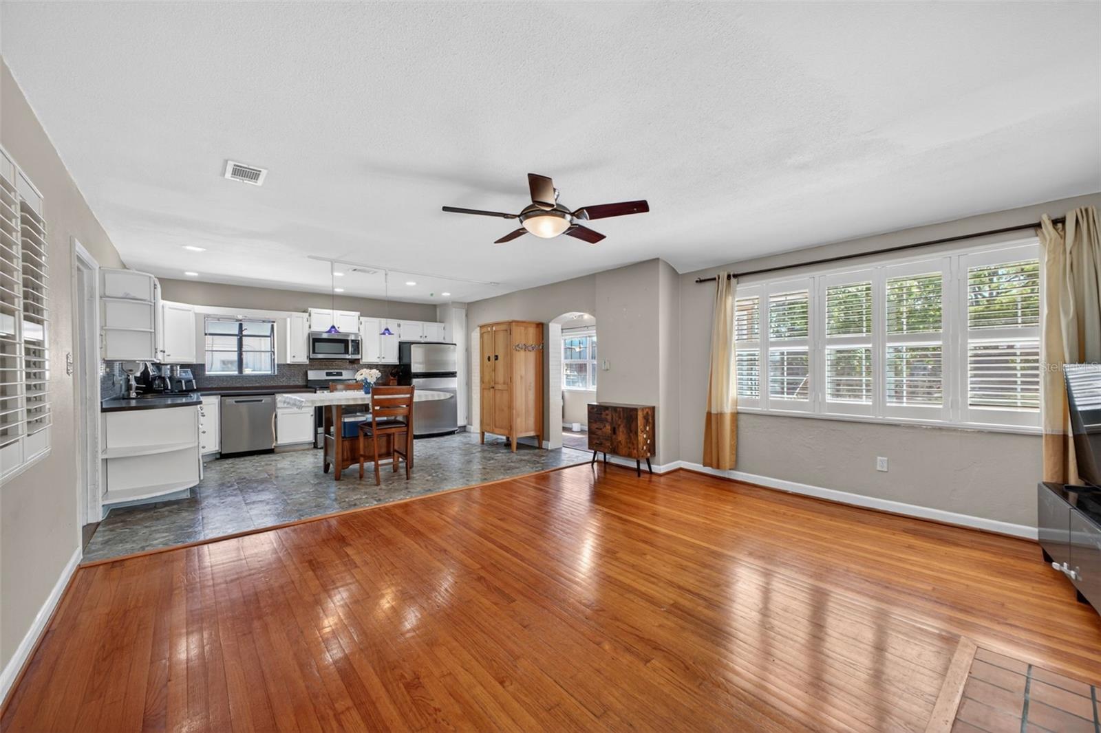 Bright open living room with natural light and wood flooring