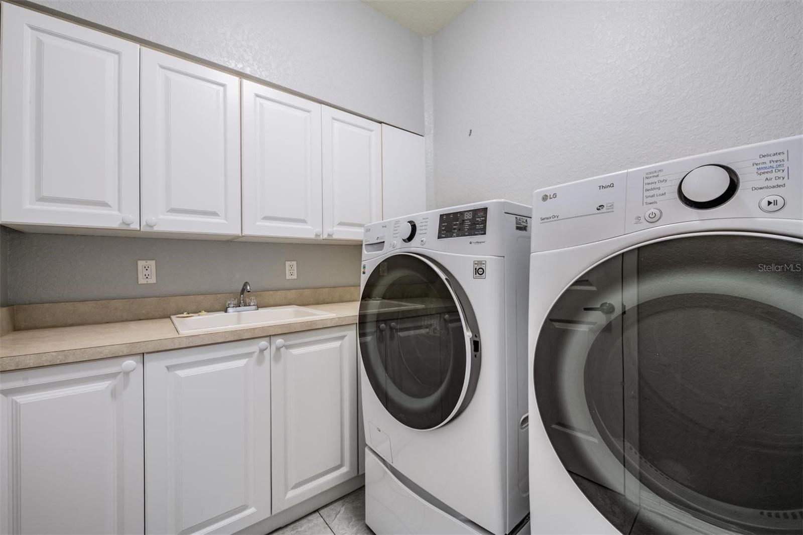 Laundry Room with cabinets and sink