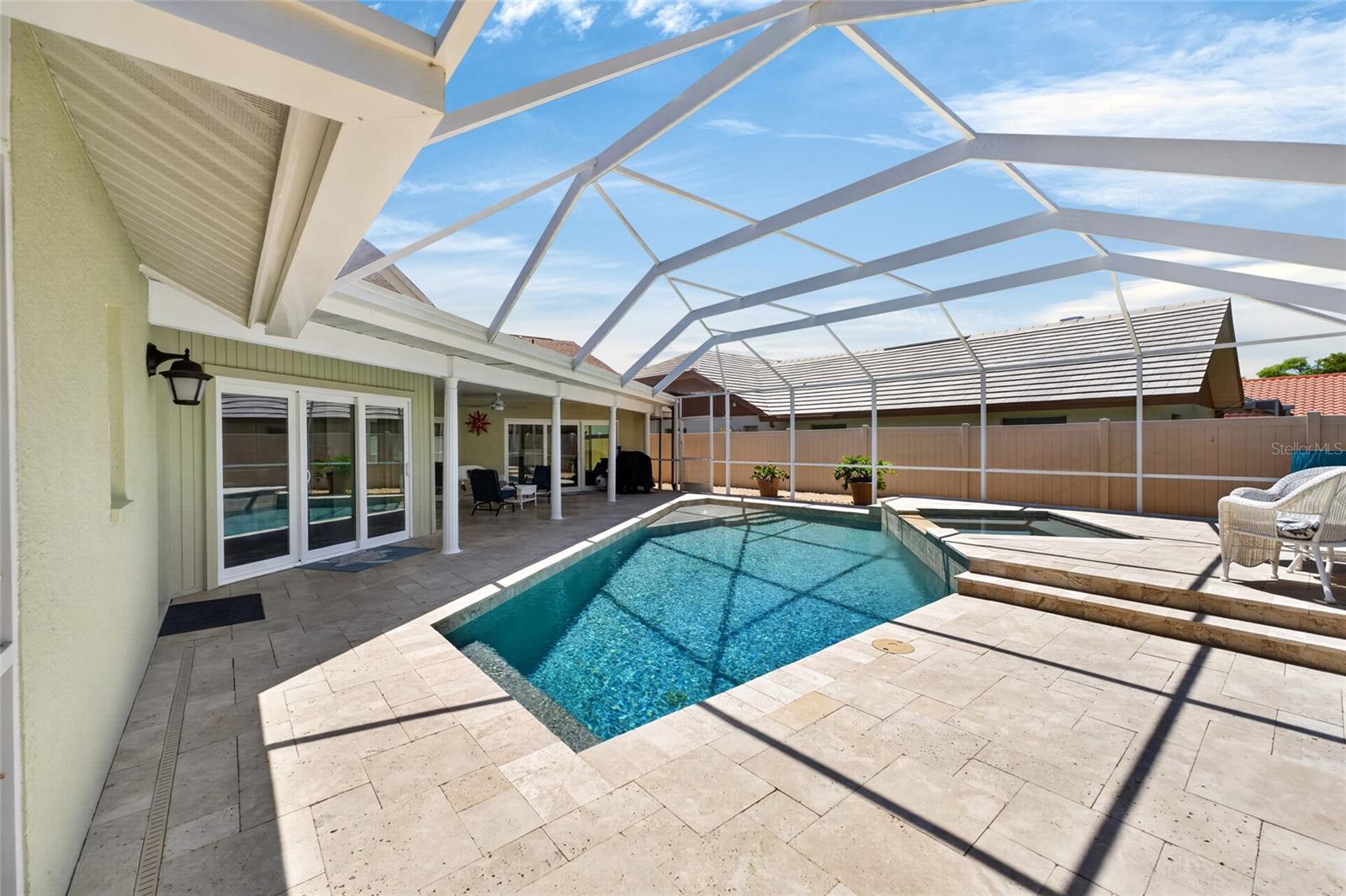 Sparkling salt water pool and spa with screen enclosure