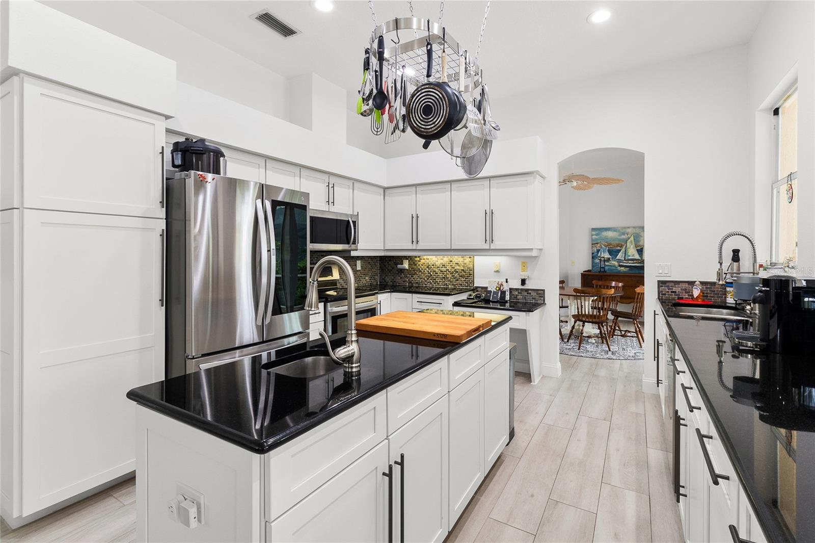 LG door-in-door instaview refrigerator, Bosch dishwasher, LG range and microwave.  Pot rack conveys.