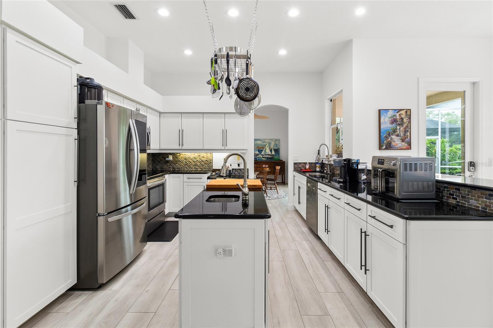 Plenty of storage, note closet pantry on left.  Breakfast room on right has breakfast bar, accommodates three to four seats