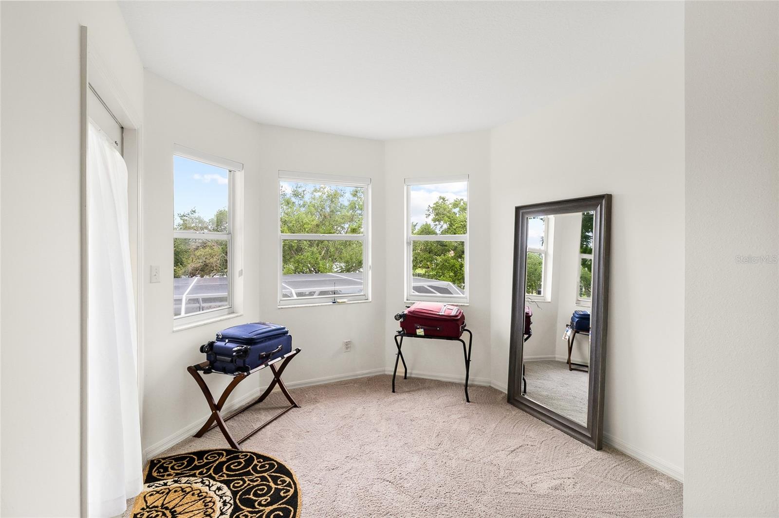 charming seating area off primary sleeping room.  Door on left accesses private balcony.