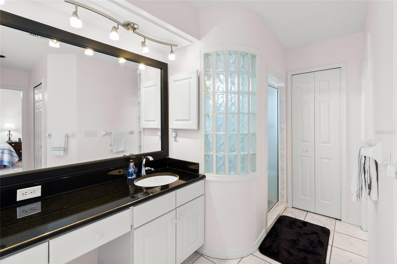 Plenty of storage for bath accessories and window in standup shower.