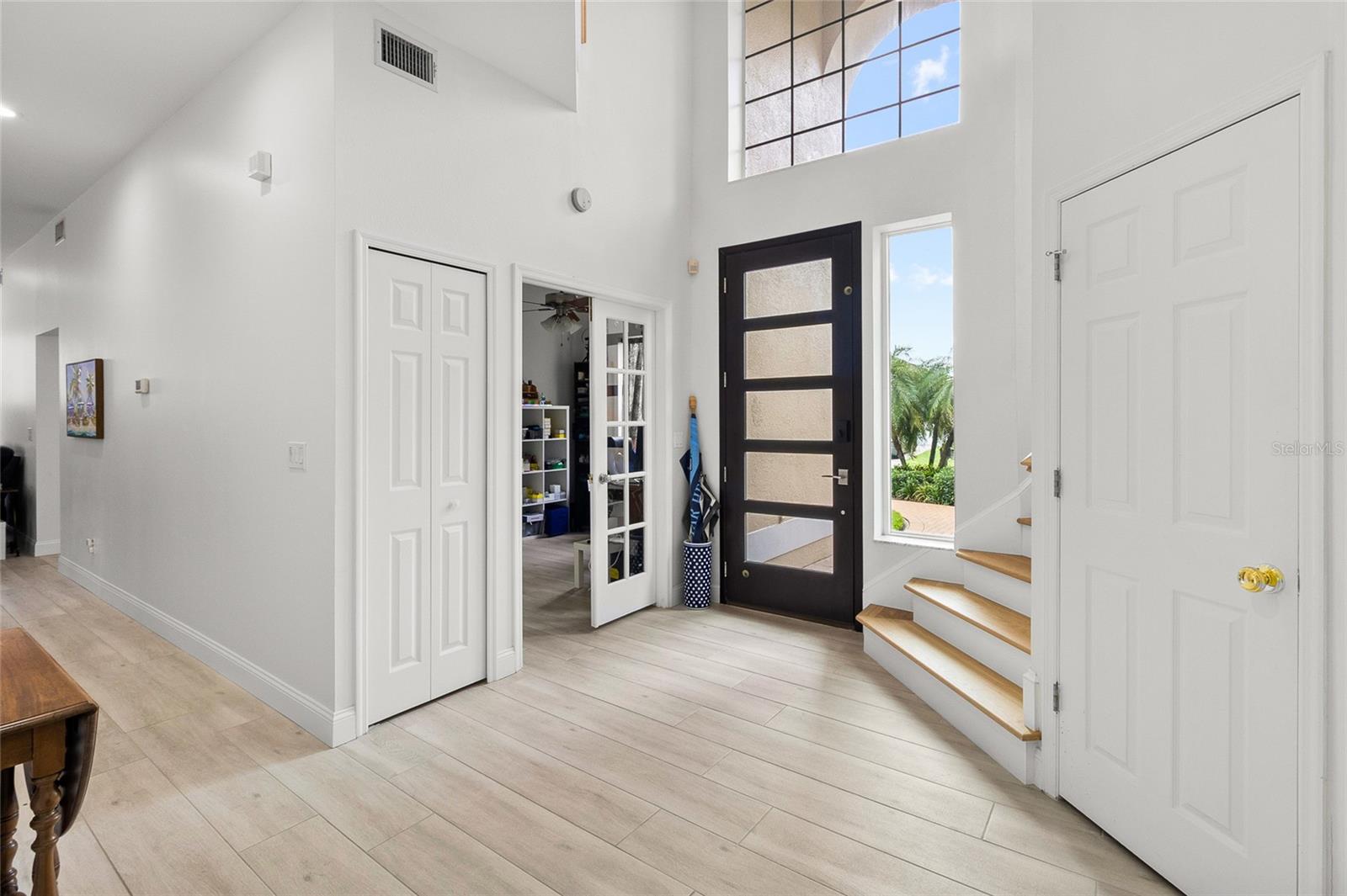 Den conveniently located close to entry.  Large under-staircase closet to right.