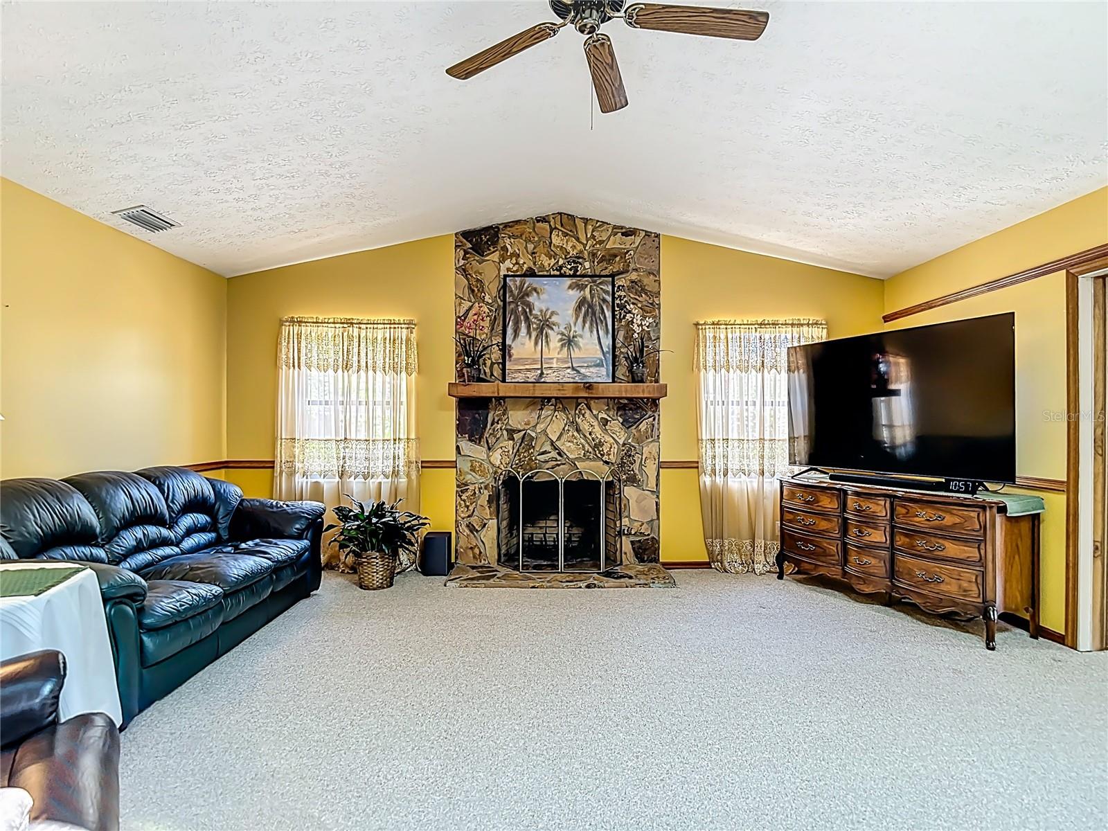 Large family room with wood-burning fireplace.