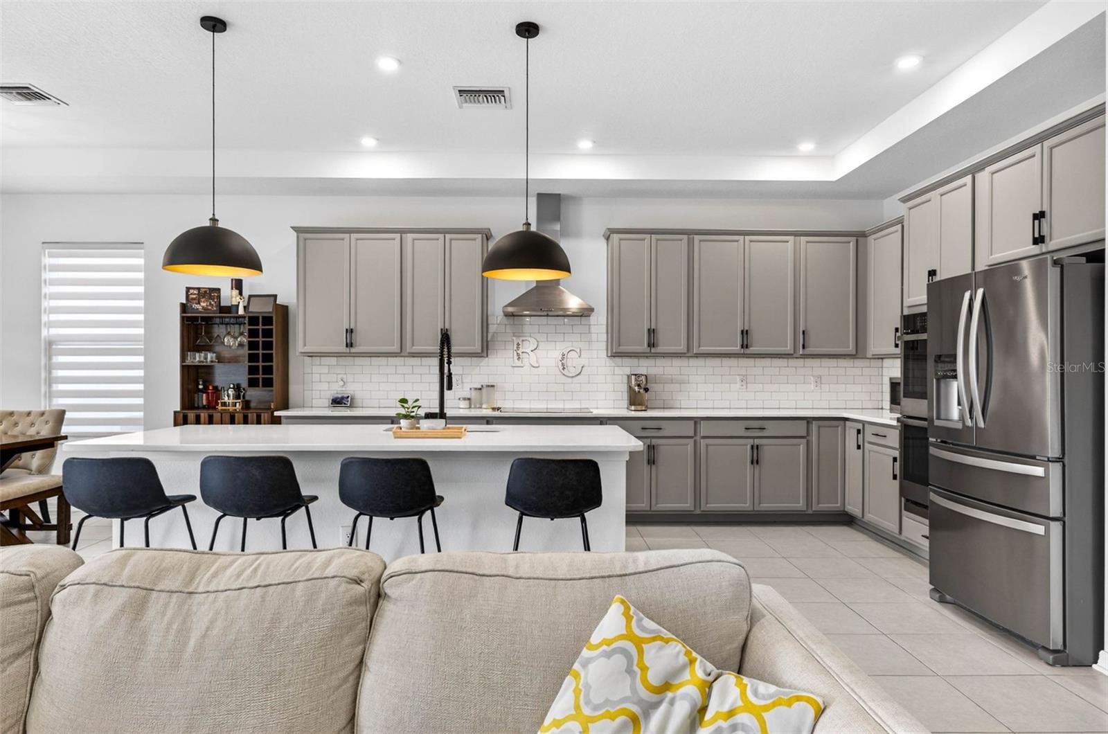 Stainless steel appliance package and quartz countertops.