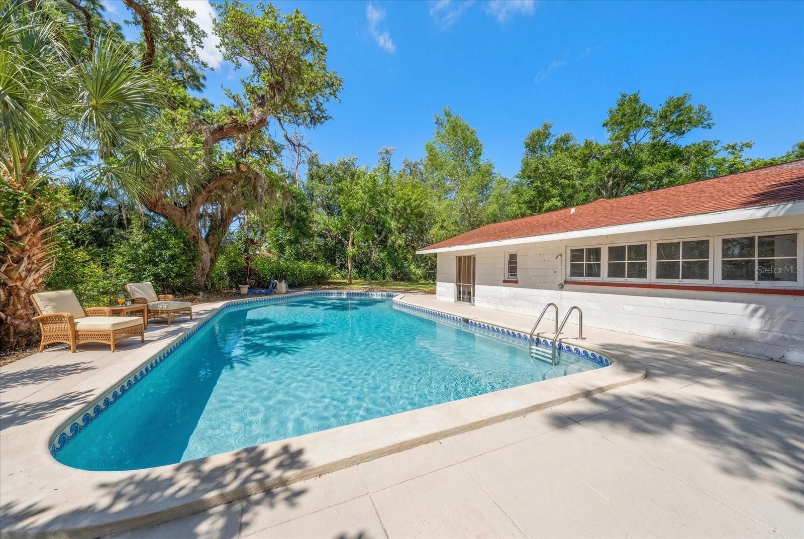 water virtually added - pool is empty. Guest house in background