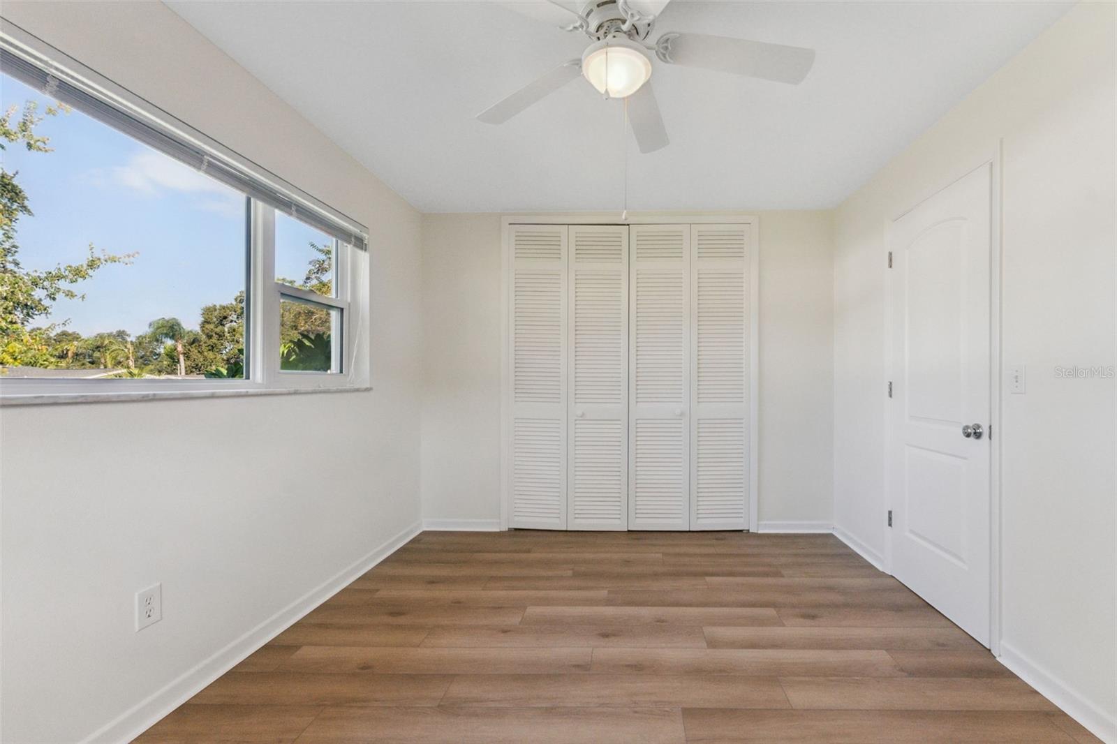 Bright and functional, Bedroom 3 features natural light and a built-in closet—perfect for comfort and organization