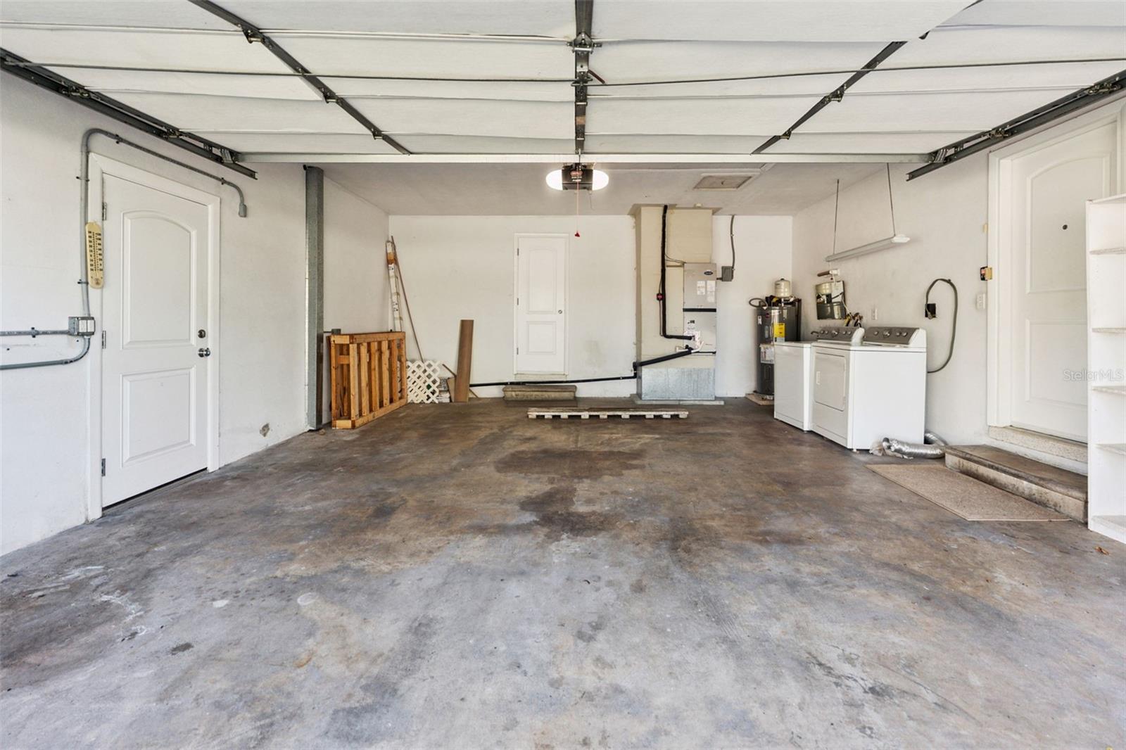 Spacious and practical, the large 2-car garage offers plenty of room for vehicles, storage, and projects