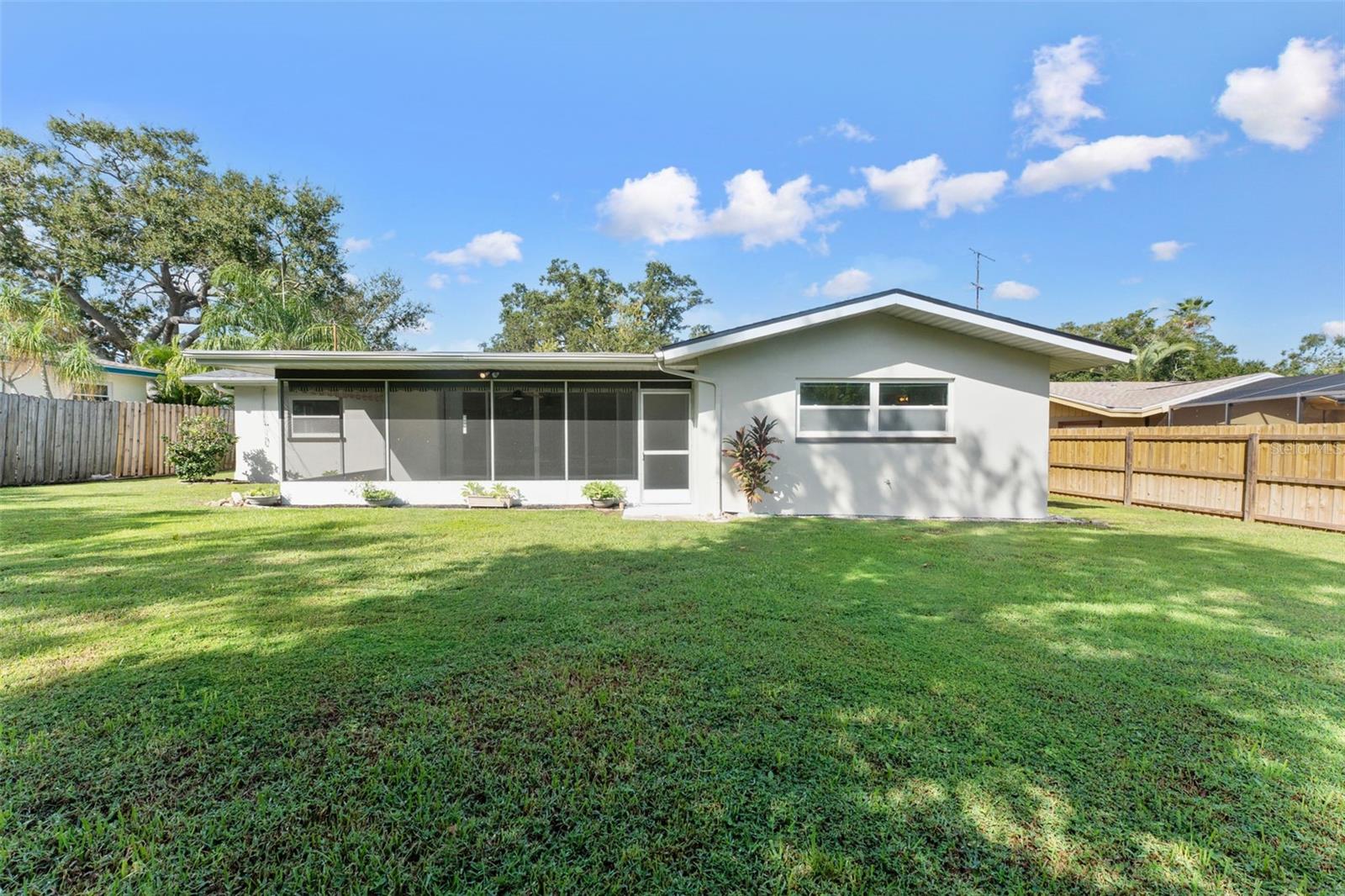 Picture-perfect from every angle—the backyard offers a view of the beautifully maintained home
