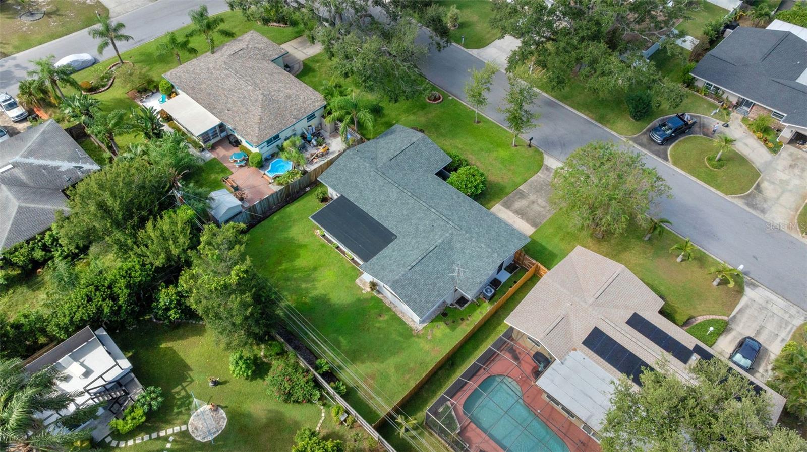 This drone shot showcases the home’s roof andspacious backyard, highlighting both style andoutdoor potential