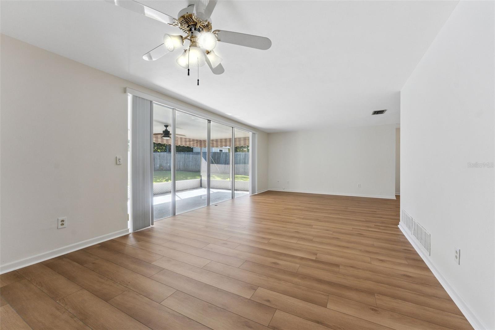 Bring the outdoors in with a large sliding glass doorthat opens seamlessly to the screened-in porch—perfect for relaxing and entertaining