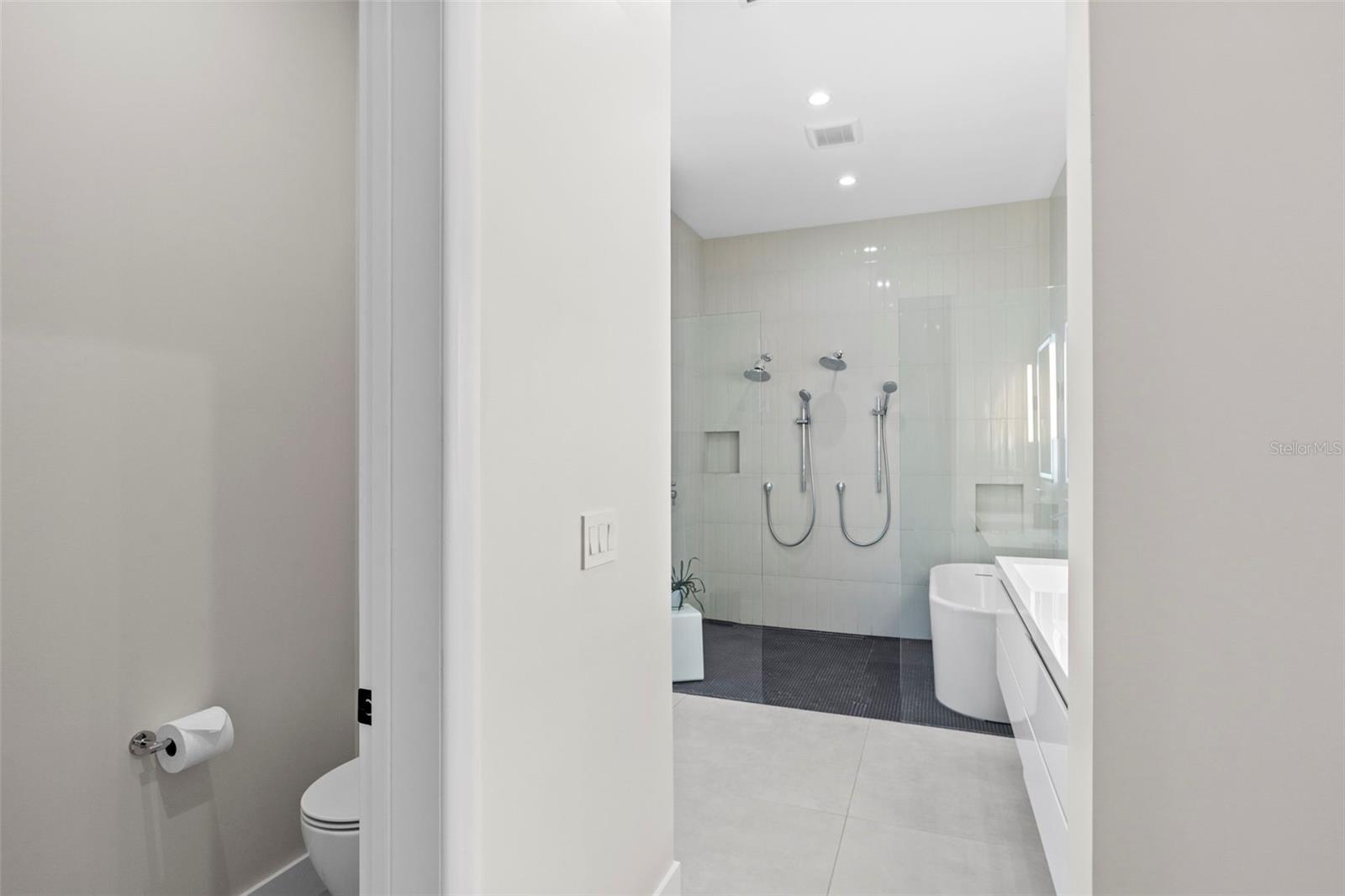 Primary En-suite Bath With Double Sinks, Dual Showers And Deep Soaking Garden Tub.