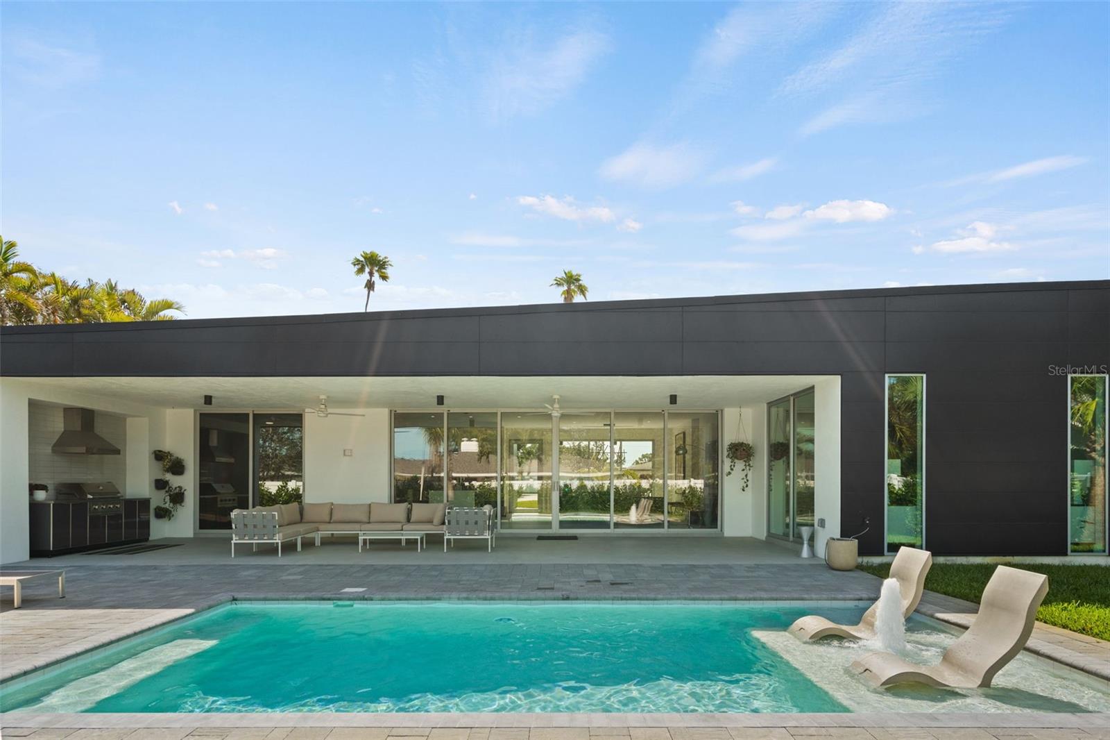 Covered Outdoor Kitchen and Living Area, Steps From Your Pool.