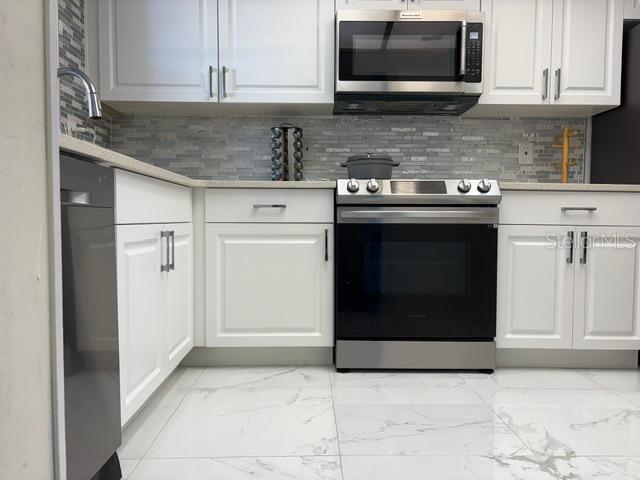remodeled new kitchen granite counters marble floor