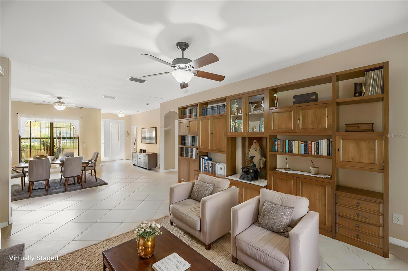The dining area and living room feature an open-concept design filled with abundant natural light.