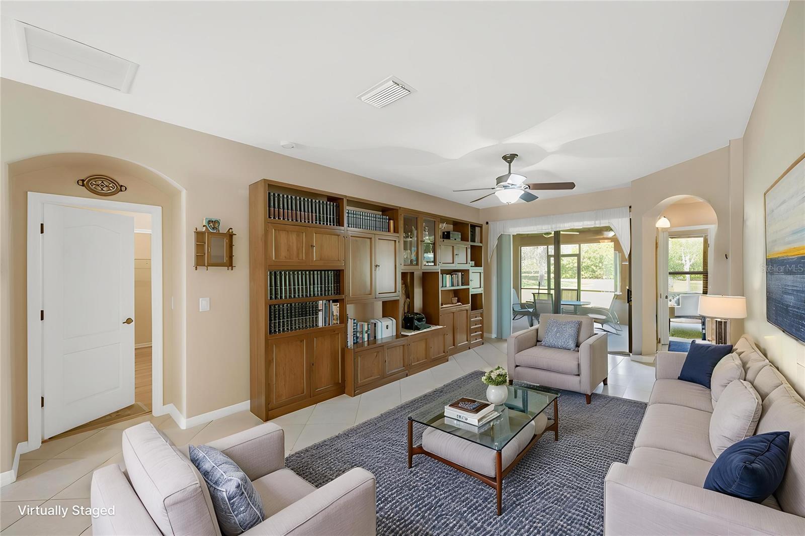 The expansive 18' x 38' living and dining area flows seamlessly through sliding doors to the covered and screened lanai, creating the perfect indoor-outdoor living space.