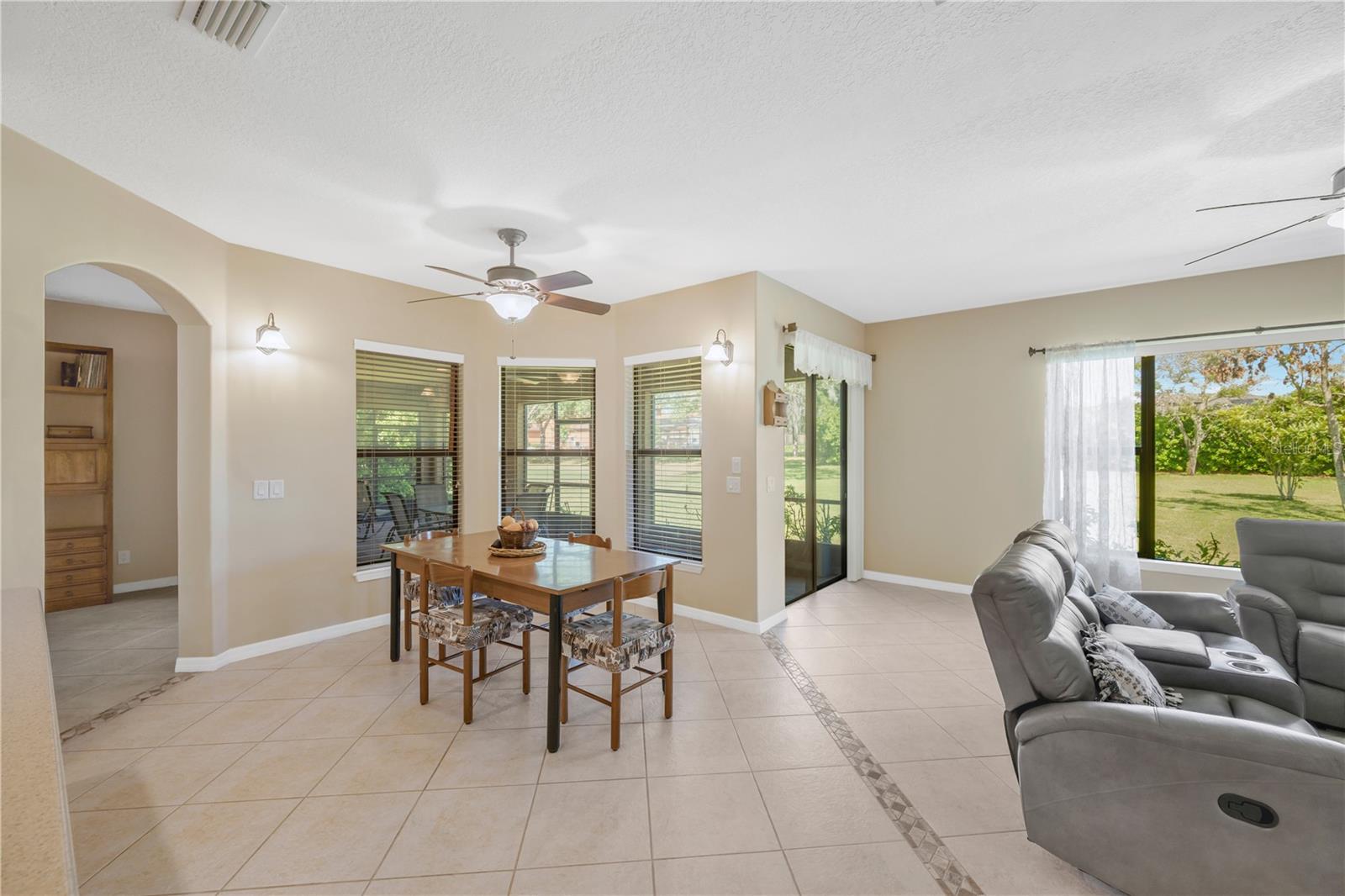 The eat-in area offers peaceful views of the back lanai and opens to the family room, creating a warm and connected gathering space.