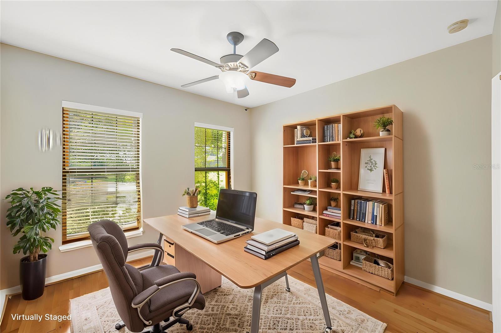 Just inside the front door is a bedroom with a built-in closet that easily serves as the perfect office, den, or flexible living space.