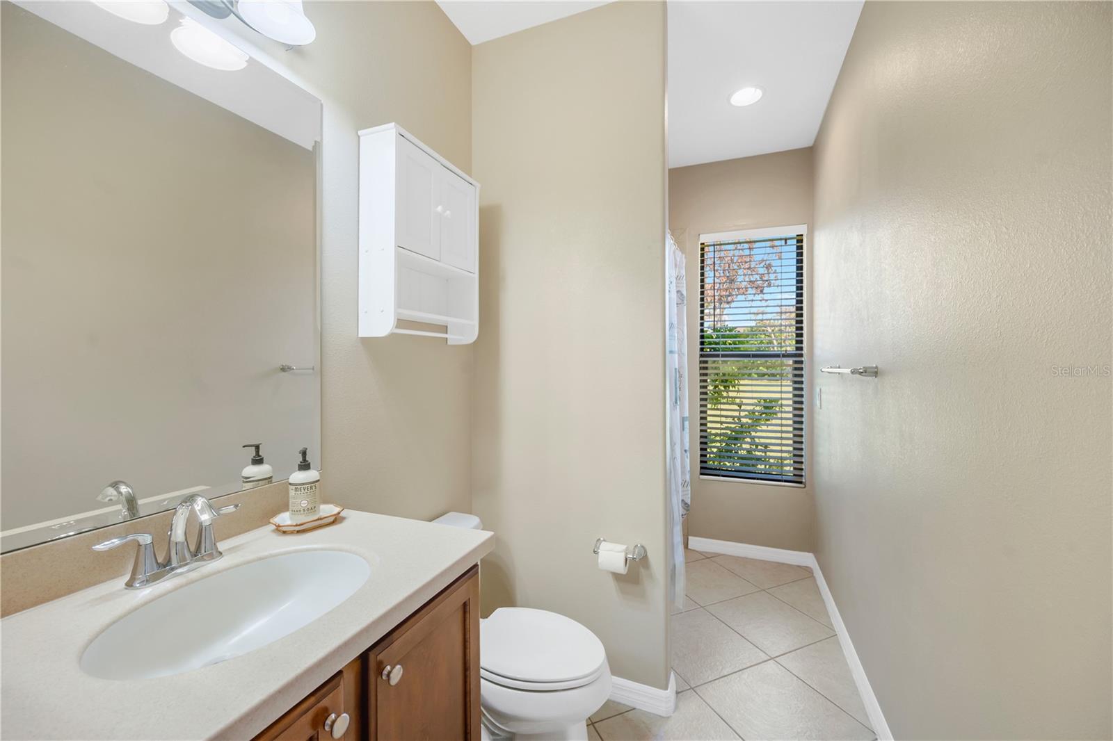 Another full bathroom with a tub/shower combination is conveniently located beside the family room and adjacent to a bedroom, making it ideal for guests or a family member seeking added privacy.