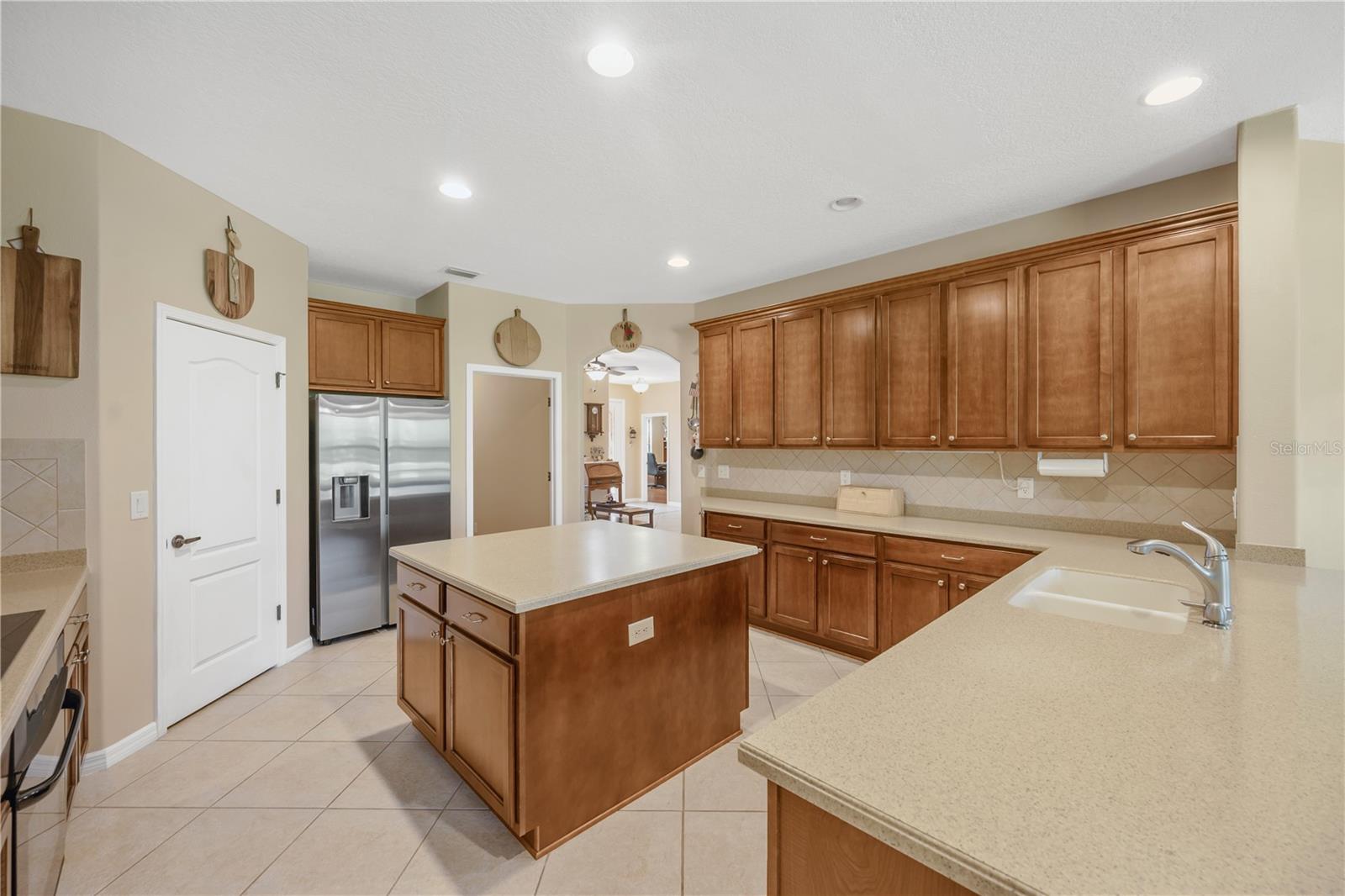The kitchen sink is seamlessly integrated into the Corian countertop, creating a smooth single-surface design with no gaps.